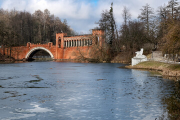 Obraz premium The Red (or Knight's) two-arched pseudo-Gothic bridge spans the channel between two large ponds in the Marfino estate