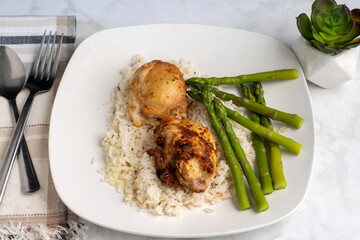 chicken thighs  on rice  with asparagus