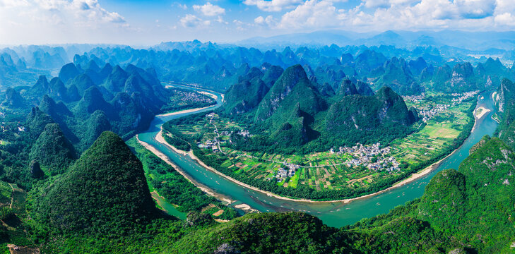 Aerial shot of the spectacular karst mountain and river with green valley landscape in Guilin, China. - Powered by Adobe