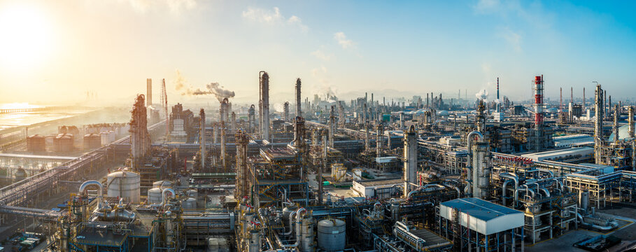 Aerial view of oil refinery and chemical plant with pipeline equipment in a large industrial area at sunrise
