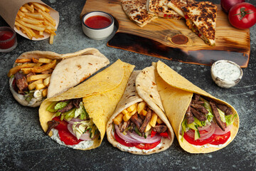 Assorted Turkish Street Food: Kebab Wrap on Wooden Table