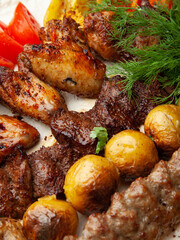 Assorted meats and vegetables cooked on the grill