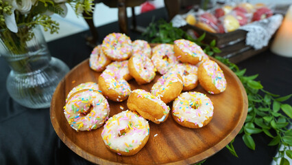 Delicious donuts served as luxurious hotel room service dessert on elegant tray