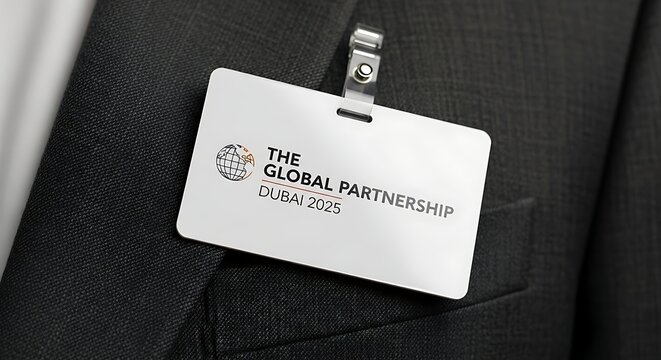 Close-up of a global partnership name tag for the Dubai 2025 conference event meeting