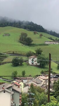 Video of a Bird of Prey Flying Over the Zambla Bassa Mountain Village, in the Italian Alps, During a Cloudy Summer Day. Wildlife Video