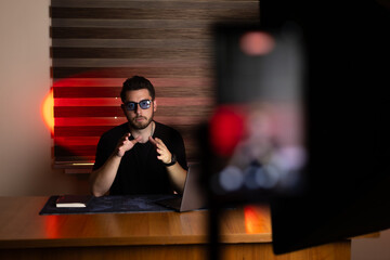 The man is recording a video for his blog or social media channel