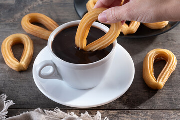 Spanish churros with hot thick chocolate in a white cup