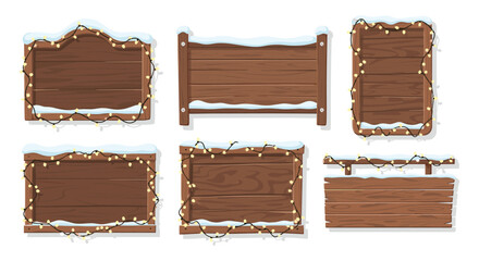 Collection of wooden signs with snow and festive lights for winter decor
