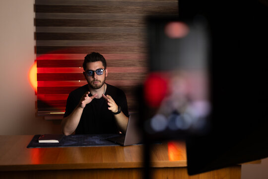 The man is recording a video for his blog or social media channel