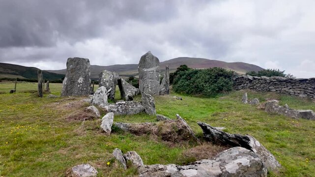 Ancient stone circle and chambered tomb on Manx moor, offering expansive countryside views toward Maughold.
