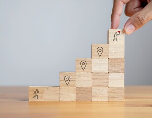 A hand places a wooden block with a goal icon on top of a staircase, symbolizing career growth and achievement.