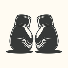 Pair of black boxing gloves facing each other, symbolizing combat and competition