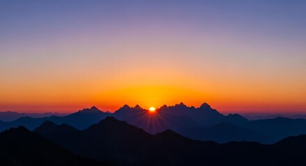 Fototapeta premium Dramatic Sunset over Silhouetted Mountain Range
