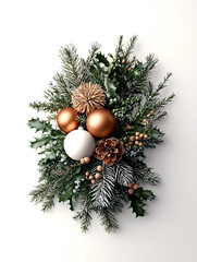 Vertical christmas composition of spruce and holly branches, matte bronze baubles, a white ornament, a glittery pine cone, centered on a white background. Luxurious winter holiday decoration concept