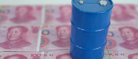 Oil barrels and yuan banknotes. business and finance concept