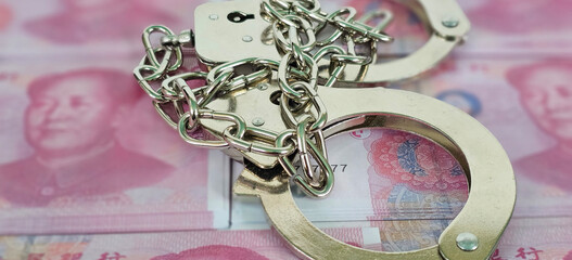 China flag with handcuffs and a bundle of dollars