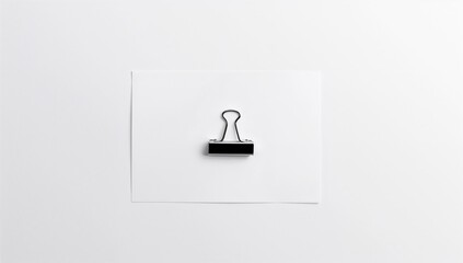 Binder clip on white paper, an efficient tool for organizing documents,
