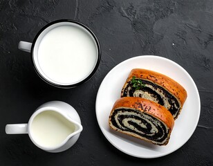 Overhead shot of milk, poppy seed pastries on plate, dark backdrop