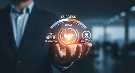 Fototapeta premium Man holding a glowing success goal teamwork strategy icon in his hand.