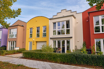 Colorful modern row houses with clean lines and bright facades in Wismar, Germany, highlighting minimalistic architecture and sustainable urban housing