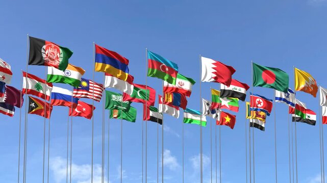 Group of asian country flags waving against a blue sky