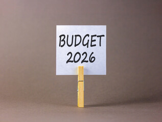 Budget 2026 symbol. Concept words Budget 2026 on beautiful white paper on wooden clothespin. Beautiful grey background. Business and budget 2026 concept. Copy space.