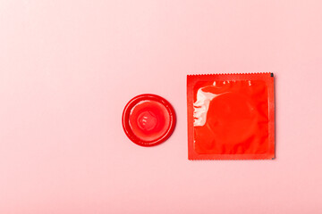 Condoms on a colored background. Colorful fruit-themed condoms in packaging. Safe sex concept. Contraceptive. Different birth control methods. Aids prevention. World AIDS Day. Sexual health.