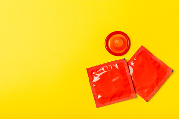 Condoms on a colored background. Colorful fruit-themed condoms in packaging. Safe sex concept. Contraceptive. Different birth control methods. Aids prevention. World AIDS Day. Sexual health.