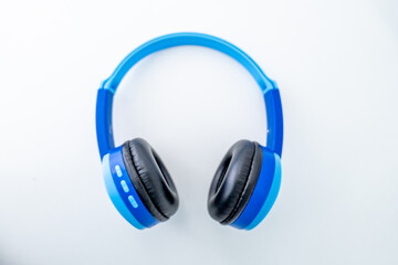Bright blue wireless children's headphones shot isolated over a white background.