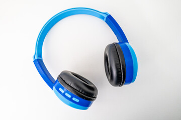 Bright blue wireless children's headphones shot isolated over a white background.