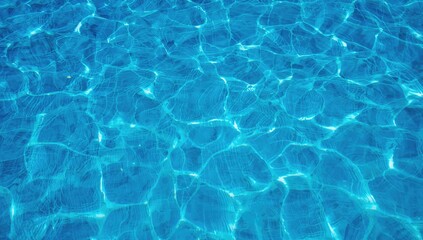 Obraz premium Blue swimming pool water with ripples and waves, refreshing backdrop for relaxation
