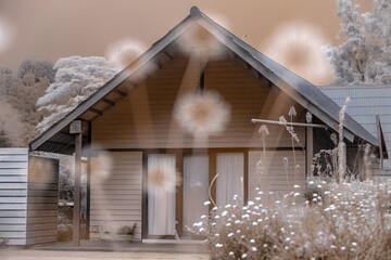 Infrared photography captures the serene beauty of a wooden house nestled amidst lush greenery and blooming flowers