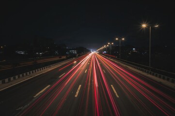 Light trails created by vehicles traveling on a busy highway at night