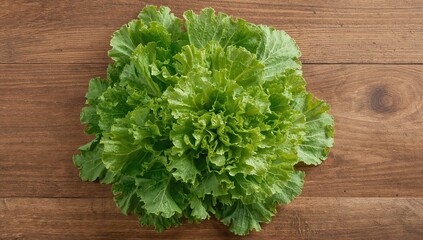 Fresh greens laid out on a rustic wooden surface