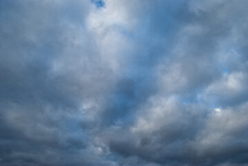 the blue sky shines through the dark clouds