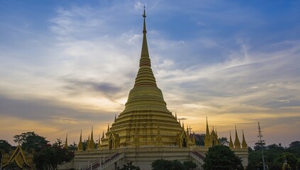 Fototapeta premium Golden Pagoda on a Hilltop at Dusk with Blue Sky Background