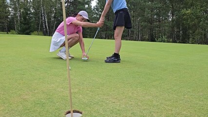 Golf practice session with a coach on the green in a serene outdoor setting
