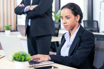 African american business woman working with laptop in modern meeting room. Multi-Ethnic Corporate Business Meeting. Female executive handling real estate project. Financial analysis.