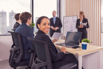 African american business woman working with laptop in modern meeting room. Multi-Ethnic Corporate Business Meeting. Female executive handling real estate project. Financial analysis.