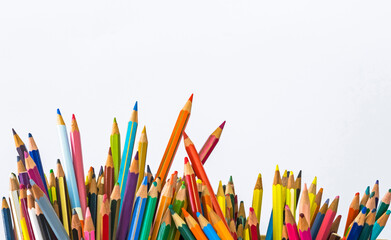 Colored pencils on a white background,
crayons of various colors on a white background, still life