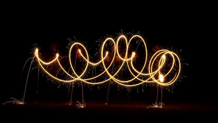 Illuminated spirals and loops of light against a stark black background, showcasing intricate patterns