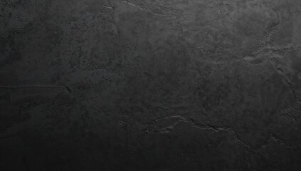 Fototapeta premium Black textured concrete wall with rough irregularities, suitable for background design