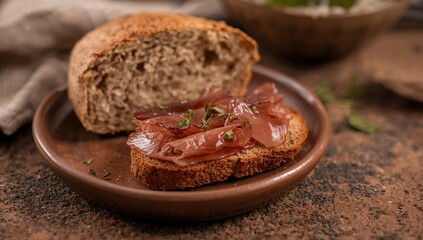 Close-Up of Dried Pork and Rye Bread Snack Served on a Rustic Brown Plate