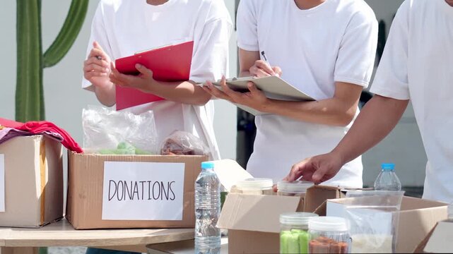 Volunteers organize donations and supplies for community support with caring hands