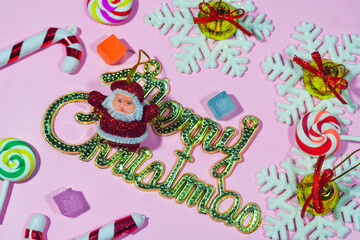 Elegant Christmas background with pink and gold decorations, including baubles, stars, and wrapped gifts. Perfect for festive holiday themes, greeting cards, and seasonal promotions