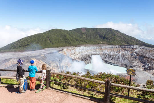 Family looking in the crater of active volcano, volcan Poas, Costa RIca