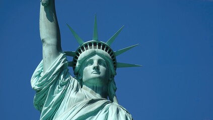 Fototapeta premium Iconic Liberty Statue. American Landmark. Close-up of Liberty's Crown. Symbol of Freedom under Clear Sky. Famous Democracy Monument.