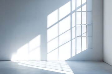 Fototapeta premium Bright light streams into a minimalist white room through a partitioned window casting shadows