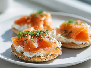 Open-faced sandwiches with smoked salmon and cream cheese on plate  