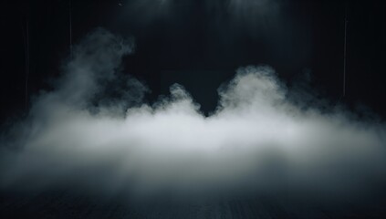 Thick white fog drifting across the floor in a dimly lit black room